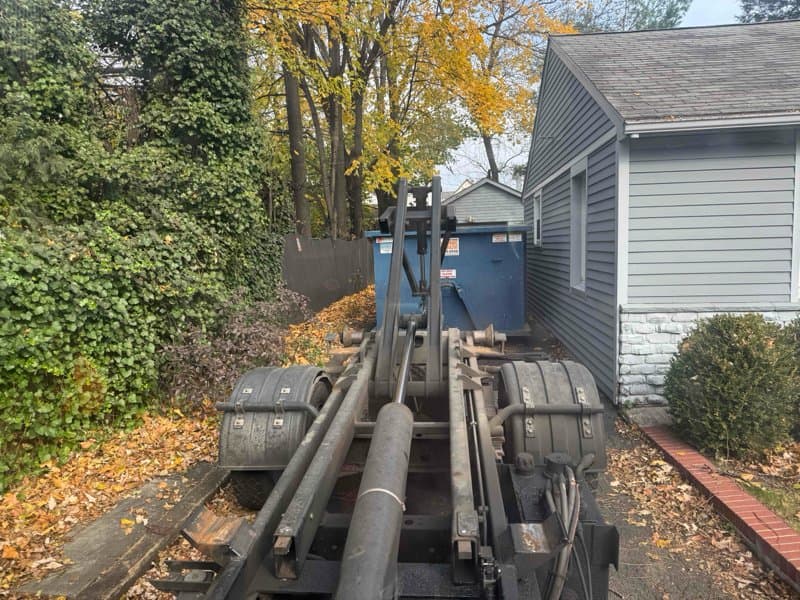 dumpster truck loading in Stamford, CT by Grizzly Junk Pros
