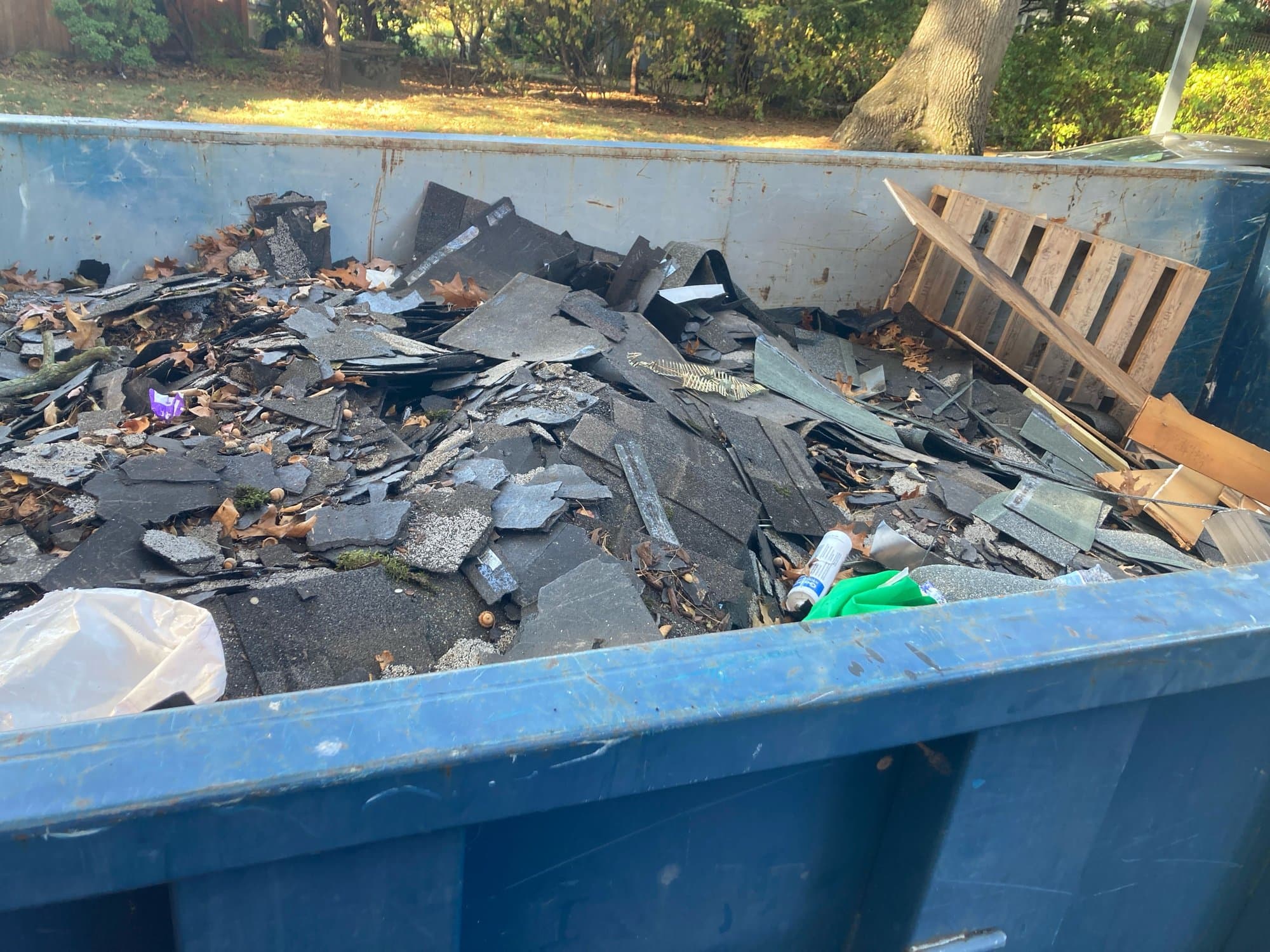 Roll-off dumpster delivery by Grizzly Junk Pros